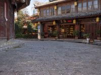 the entrance to a small shop with chinese lanterns hanging from the door and outside of it