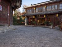 the entrance to a small shop with chinese lanterns hanging from the door and outside of it