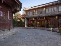 the entrance to a small shop with chinese lanterns hanging from the door and outside of it