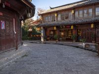 the entrance to a small shop with chinese lanterns hanging from the door and outside of it