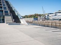 a building with stairs going down to a walkway next to a river thames waterway in a city