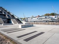 a building with stairs going down to a walkway next to a river thames waterway in a city