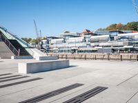 a building with stairs going down to a walkway next to a river thames waterway in a city