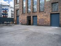 a street view of an alley with an outdoor table and chairs in front of a building