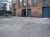 a street view of an alley with an outdoor table and chairs in front of a building