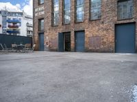 a street view of an alley with an outdoor table and chairs in front of a building