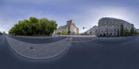 a fisheye lens of a building, street, and intersection in europe, on a clear day