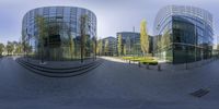 the reflection of some modern buildings in a fish - eye lens is clearly seen in a video