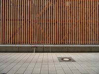 a group of people riding skateboards near wooden panels and stairss with artwork on them