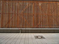 a group of people riding skateboards near wooden panels and stairss with artwork on them