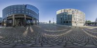 two circular panoramic images in a building next to an intersection of a street and parking