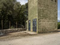 there is a large building with several blue doors on it at the bottom of the building