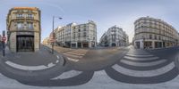 this is a panoramic image of paris buildings and people at the intersection of a busy street