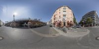 a photo of a person riding his bike through the street in europe on a city street