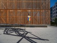 a group of people riding skateboards near wooden panels and stairss with artwork on them