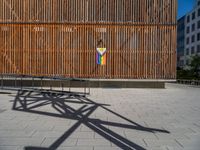 a group of people riding skateboards near wooden panels and stairss with artwork on them