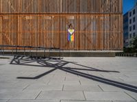 a group of people riding skateboards near wooden panels and stairss with artwork on them