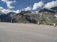 a skateboarder is riding near the mountains on a highway and having fun skateboarding