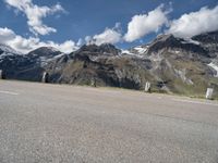 a skateboarder is riding near the mountains on a highway and having fun skateboarding