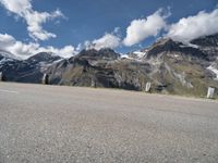 a skateboarder is riding near the mountains on a highway and having fun skateboarding