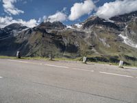 a skateboarder is riding near the mountains on a highway and having fun skateboarding