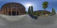 an 360 - view image of the street with a building and tree on the side