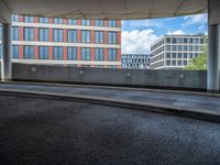 a car is driving on the highway through an underground parking garage area in a city