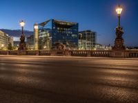 the city skyline is at night from the street level with traffic and pedestrians walking on it