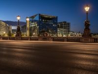 the city skyline is at night from the street level with traffic and pedestrians walking on it