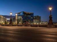 the city skyline is at night from the street level with traffic and pedestrians walking on it