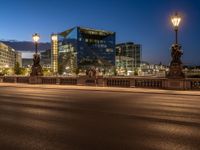 the city skyline is at night from the street level with traffic and pedestrians walking on it