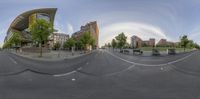 an image of a city view with 360 - lens, from the camera lens showing some buildings in the background