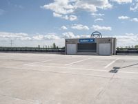 a parking lot with a building in the background and a lot for motorcycles to drive