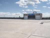 a parking lot with a building in the background and a lot for motorcycles to drive