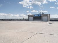 a parking lot with a building in the background and a lot for motorcycles to drive