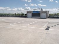 a parking lot with a building in the background and a lot for motorcycles to drive