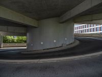 a car is driving on the highway through an underground parking garage area in a city