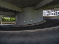 a car is driving on the highway through an underground parking garage area in a city