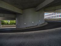 a car is driving on the highway through an underground parking garage area in a city