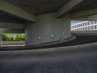 a car is driving on the highway through an underground parking garage area in a city