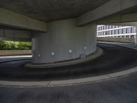 a car is driving on the highway through an underground parking garage area in a city