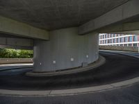 a car is driving on the highway through an underground parking garage area in a city