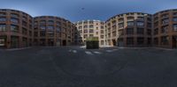 a panoramic view looking down the middle street with an intersection and buildings in the background