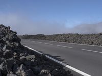 the road has been closed to traffic as it travels by itself in front of a very dry mountain