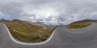 the view of a wide highway on a cloudy day, from a fish - eye view of the sky