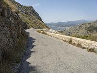 a lone motorcycle rides along a winding road by the ocean or mountains in croatia, near kaste