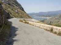 a lone motorcycle rides along a winding road by the ocean or mountains in croatia, near kaste