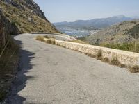 a lone motorcycle rides along a winding road by the ocean or mountains in croatia, near kaste