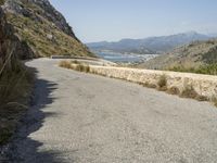 a lone motorcycle rides along a winding road by the ocean or mountains in croatia, near kaste