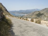 a lone motorcycle rides along a winding road by the ocean or mountains in croatia, near kaste